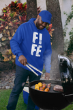 FIFE in distressed white block letters, worn on a hoodie